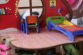 a child's room with a table and chairs